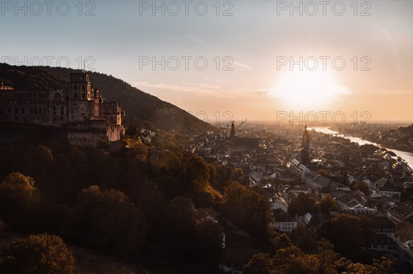 View of the city of Heidelberg with a castle on the hill and a river at sunset, Heidelberg,