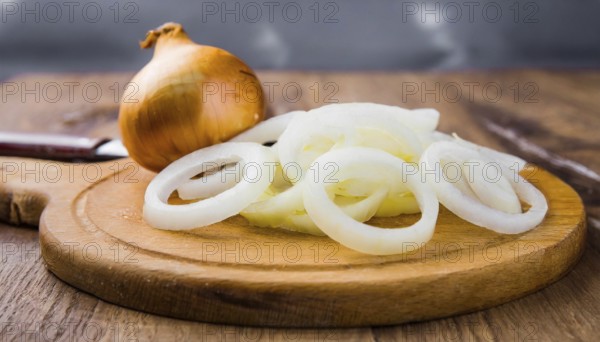 Vegetables, onion, Allium cepa, freshly cut onion rings on a wooden board, Studio