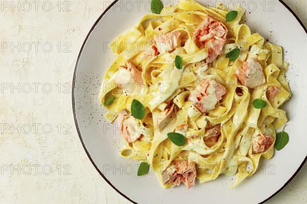 Tagliatelle pasta, in cream sauce with salmon, homemade, no people