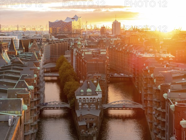 Aerial view of Speicherstadt Hamburg with Fleetschlösschen and Elbe Philharmonic Hall at sunset,