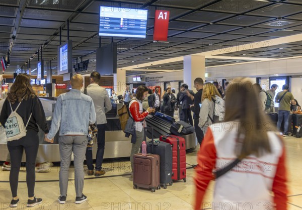 Berlin-Brandenburg BER Airport. Passengers waiting for their suitcases at baggage reclaim. Berlin,