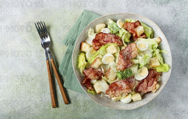 Caesar salad with fried bacon, quail eggs, homemade, no people