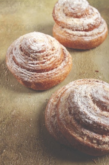 Bakery product, lemon twist, with white glaze, sweet bun, muffin, pastries, top view, no people