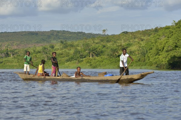 Fisher family on a pirogue on the Congo River, near Tshumbiri, Bandundu Province, Congo, Africa