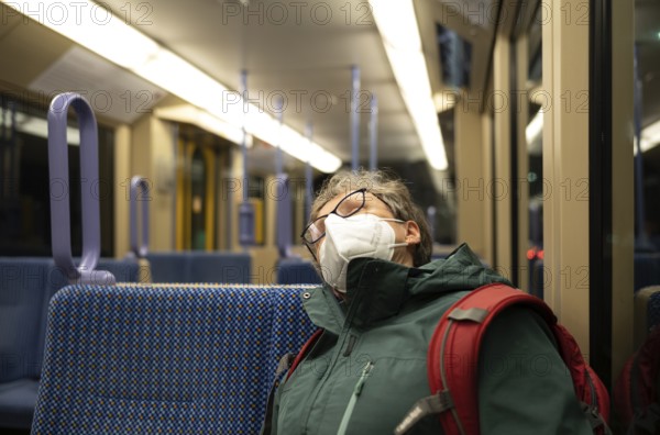 Older woman with mouth mask, sleeping, sitting in underground, Corona crisis, Stuttgart,