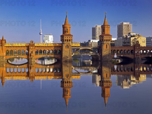 Oberbaum Bridge over the Spree with yellow underground and television tower,