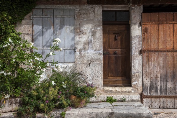 Old house façade with door and window, Moustiers-Sainte-Marie, Département Alpes-de-Haute-Provence,
