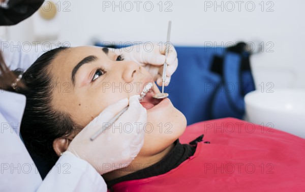 Close up of a dental specialist cleaning a patient's teeth. Close up of professional dentist