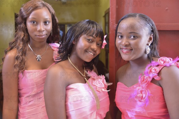 Three ladies in pink dresses at a wedding, "Pink Wedding", Freetown, Sierra Leone, Africa