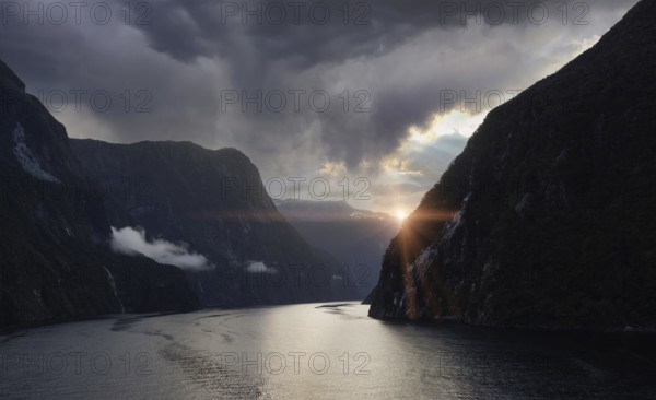 Panoramic view of scenic landscape of Milford Sound fjords in New Zealand at sunset.