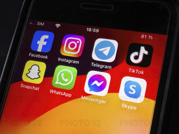 Apps programmes icons for software on display of smart device smartphone mobile phone phone iPhone