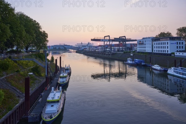 Vincke Canal with container bridge of duisport, Duisburger Hafen AG at sunrise in Ruhrort,