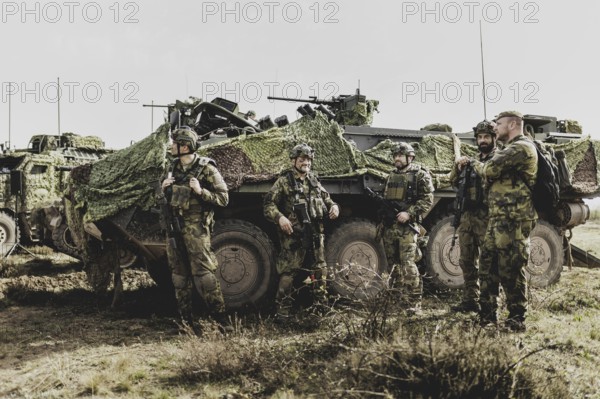 Soldiers in front of a Pandur II 8x8 of the Czech army, taken during an exercise of the Bundeswehr