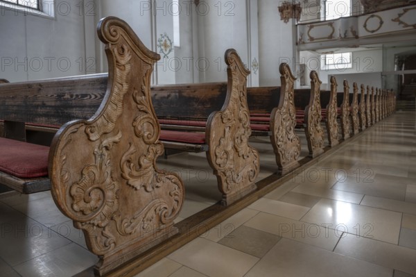 Historic, wood-carved cheeks of church pews, Heilig Kreuz Minster, Rottweil, Baden-Württemberg,