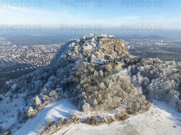Aerial view of the snow-covered Hegau volcano Hohentwiel with Germany's largest castle ruins,