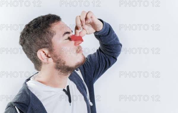 Concept of nasal congestion and nosebleed. Person with nosebleed isolated