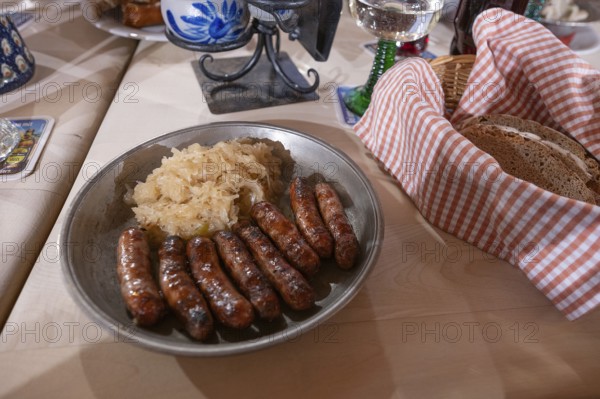 Nuremberg sausages with sauerkraut served on a pewter plate, Nuremberg, Middle Franconia, Bavaria,