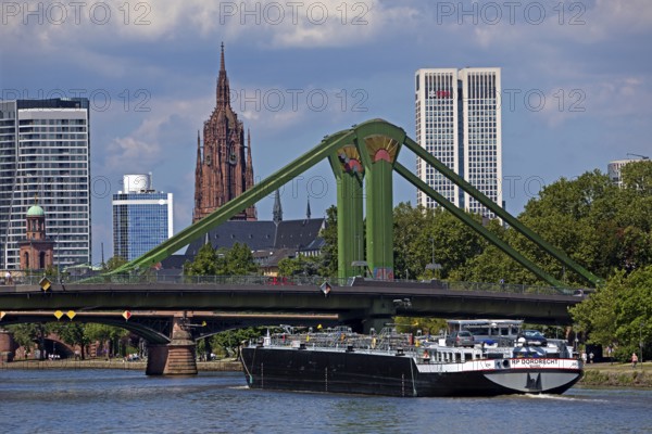 The river Main with a barge in front of the rafter bridge and the imperial cathedral of St