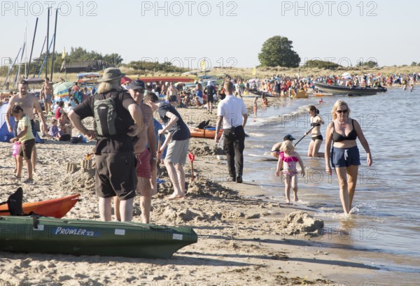 Late afternoon crowded summer sandy beach, Studland Bay, Swanage, Dorset, England, UK