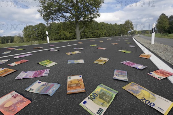 Symbolic image on the subject of subsidies, waste of money, money for road construction, etc