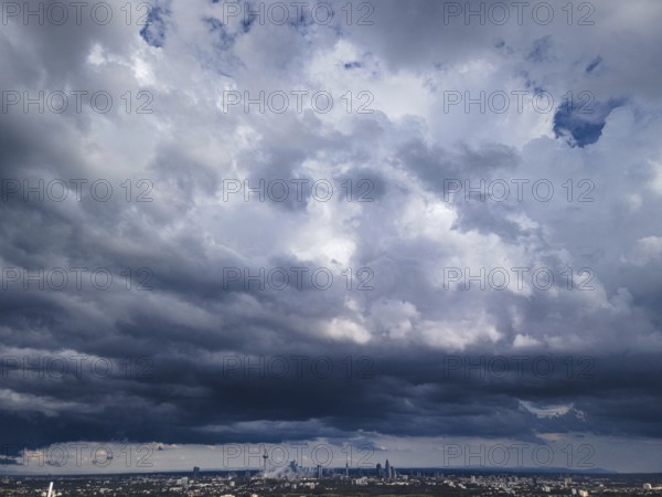 Heavy rain clouds pass over Frankfurt am Main and the banking skyline. The weather is expected to