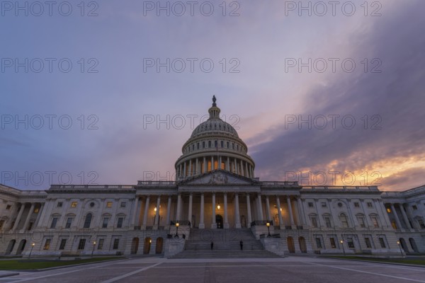 Violet sunset sky over the US Capitol building dome