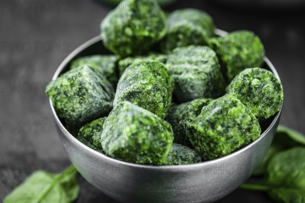 Frozen spinach cubes as detailed close up shot (selective focus)