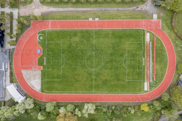 Aerial drone view of a soccer field with a red running track