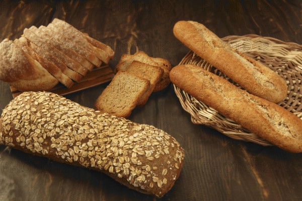 Varied bread still life over dark wood background