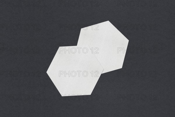 Two white hexagon shapes overlapping on a dark background, Blank white Business card mockup stacks