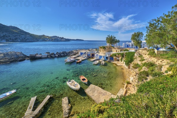 Beautiful view of secluded Mediterranean island harbour on summer day. Whitewashed houses, hills,