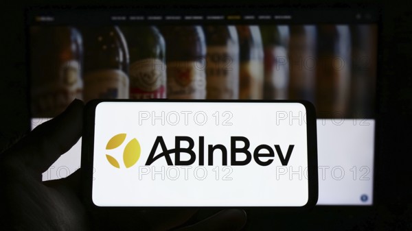 Stuttgart, Germany, 04-04-2023: Person holding smartphone with logo of brewing company