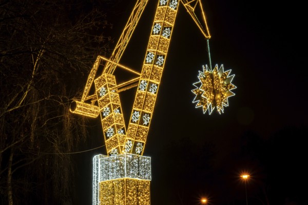 Construction crane symbol of Shipyard Holiday illuminated decorations in Gdansk Poland. Beautiful