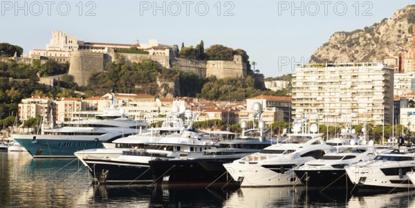 Monte Carlo, Monaco, August 2022: Port Hercule with luxury yachts, boats, and scenery skyline,