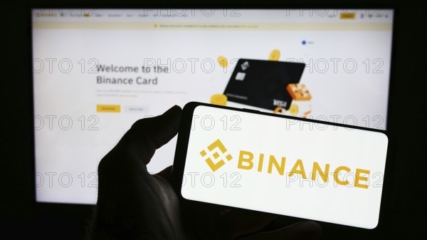 Stuttgart, Germany, 03-31-2023: Person holding mobile phone with logo of crypto exchange company