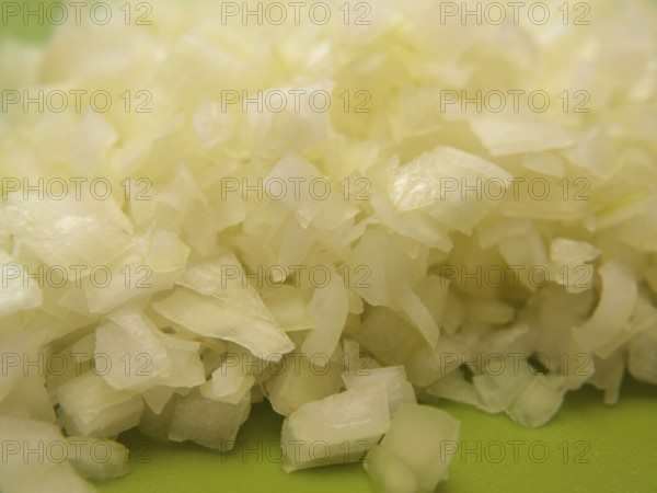 Closeup of freshly chopped onion, on chop board