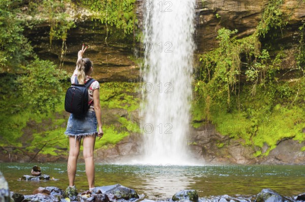Jung woman in front of waterfall, Maquine, Rio grande do sul, Brazil, South America