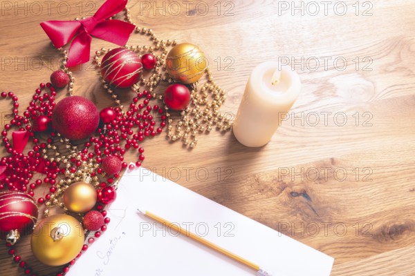Conceptual image with a letter addressed to Santa, on a wooden table, surrounded by Christmas