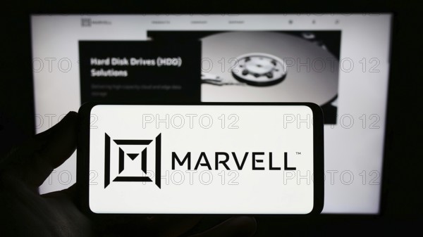 Stuttgart, Germany, 12-30-2022: Person holding smartphone with logo of US semicondurctor company