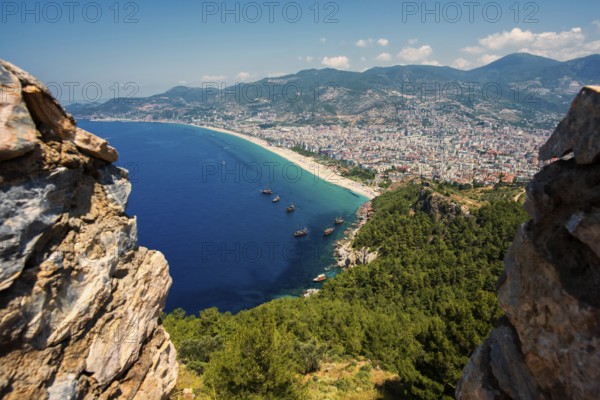 View from the castle hill over the town of Alanya with Klopatra Beach and tourist boats, Turkish