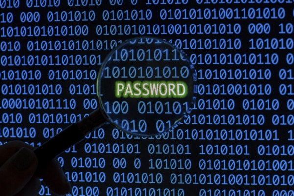 Password with binary code hand holding magnifying glass