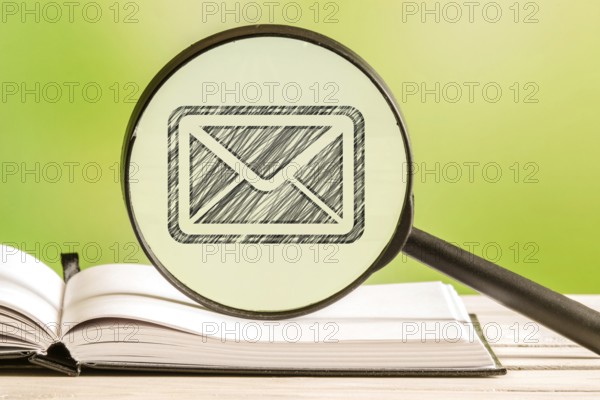 Mail search with a pencil drawing of a letter in a magnifying glass