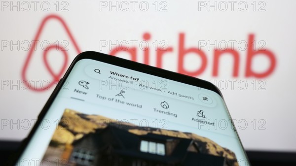 Stuttgart, Germany, 11-30-2022: Mobile phone with webpage of US homestay marketplace company Airbnb