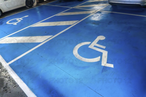 A parking lot with a blue handicap parking sign