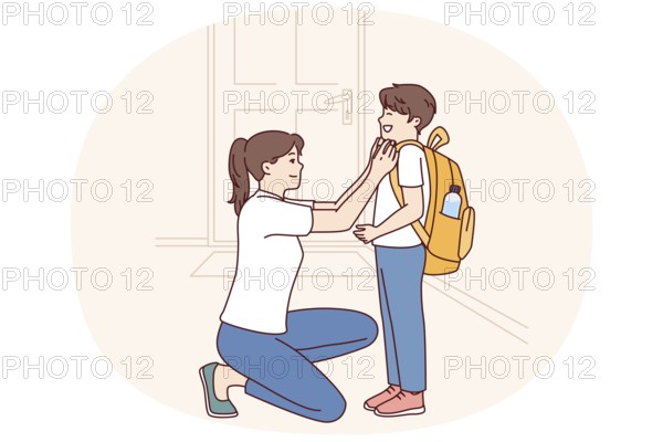 Single mother prepares young son of student in elementary school as trip to lessons and helps to
