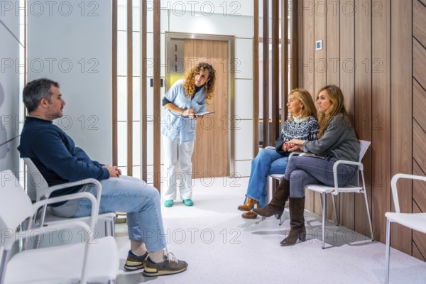 Nurse checking the list of patients in the waiting room of an hospital