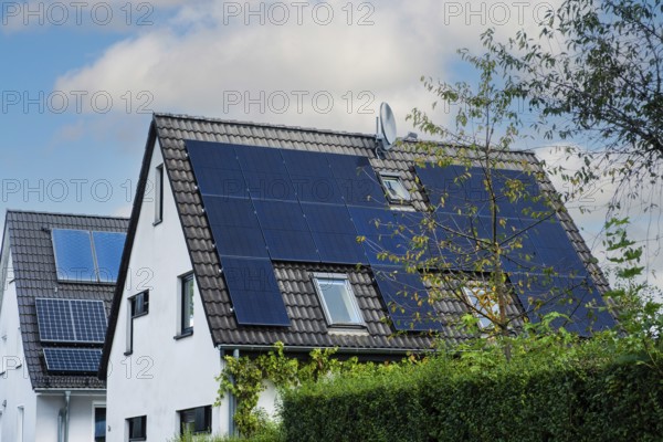Solar panels and solar thermal energy on the roof of a detached house in Essen, Germany, Europe