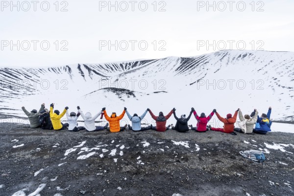A group of adventurous friends on the Hverfjall volcano in Myvatn Nature Park, Iceland. Concept of