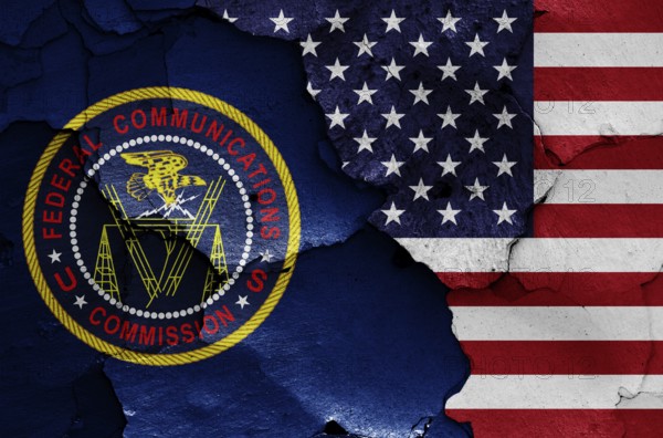 Flags of Federal Communications Commission and USA painted on cracked wall