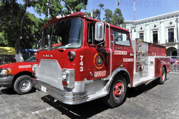 Merida, Yucatan, Mexico, Central America, Red fire engine on a city street, surrounded by historic